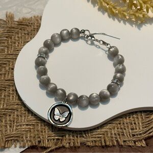 Cat’s eye glossy beads bracelet with butterfly disc pendant